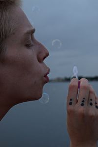 Close-up of woman blowing bubbles