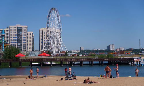 People at amusement park in city