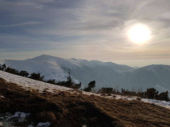 Scenic view of snowcapped mountains against sky