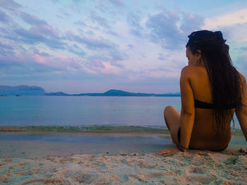 Woman on beach against sky