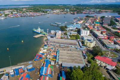 High angle view of cityscape by sea against sky