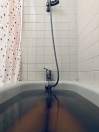 Water filling in bathtub at bathroom