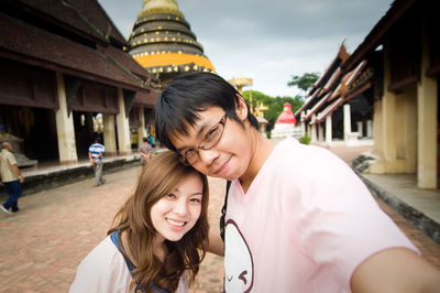 Portrait of smiling couple at temple