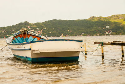 Boats moored in lake