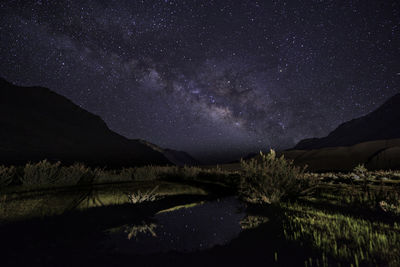 Scenic view of mountains against sky at night