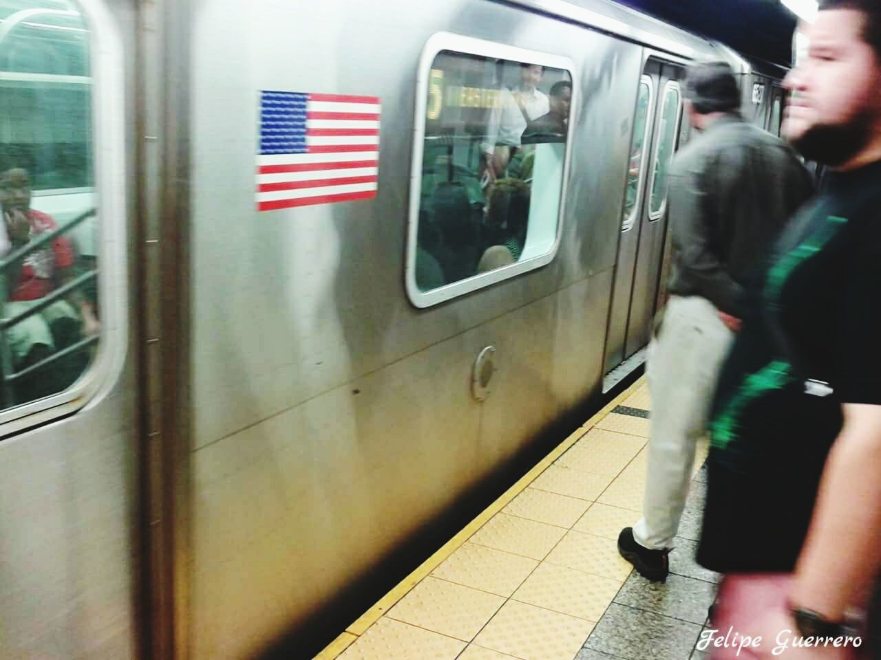 TRAIN ON RAILROAD STATION PLATFORM