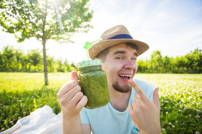 Portrait of smiling young man against plants