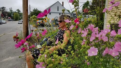 Woman with pink flowering plants