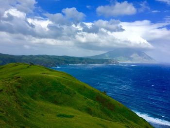 Scenic view of sea and mountains against sky