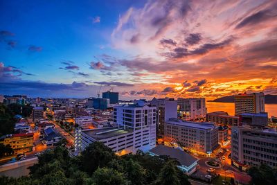 High angle view of illuminated buildings against sky at sunset