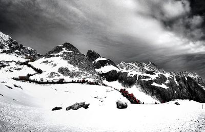 Scenic view of snow covered mountains against sky