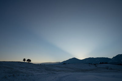 Scenic view of snowcapped mountains against clear sky