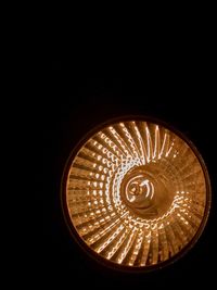 Low angle view of illuminated lamp in darkroom