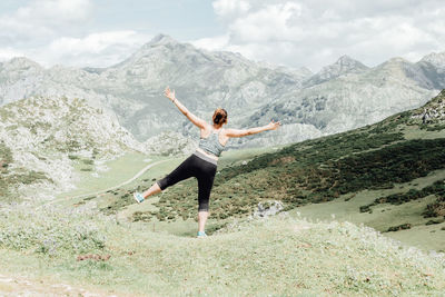 Full length of woman standing on mountain