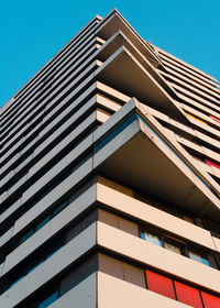 Low angle view of modern building against clear blue sky