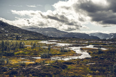 Scenic view of lake and mountains against sky