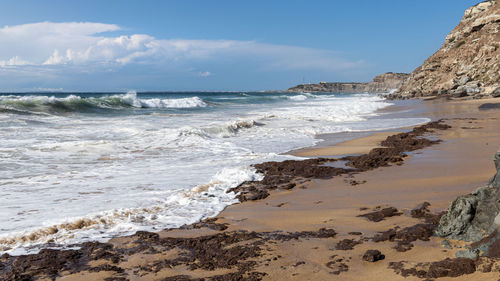 Scenic view of beach against sky