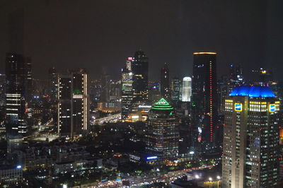 Illuminated buildings in city at night