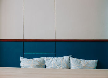 White wall with umbrella on bed