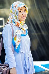 Portrait of smiling young woman wearing hijab