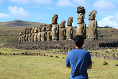 Rear view of man standing against rock formation