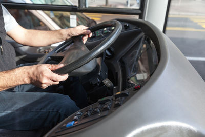 Midsection of man driving car