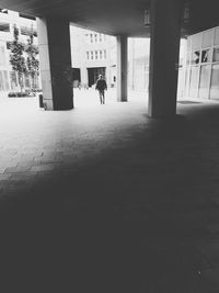 Silhouette people walking in corridor of building