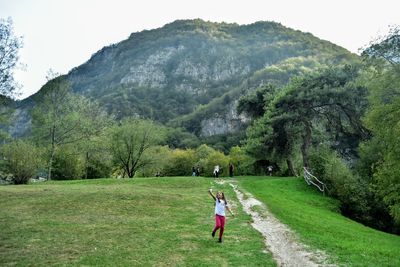 Rear view of woman on landscape against mountains