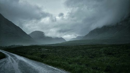 Empty road leading towards mountains