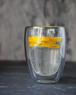 Refreshing drink for a hot day with mineral water and lemon in a glass glass close-up