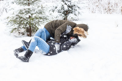 Person with umbrella on snow covered field