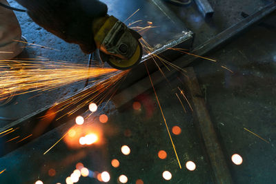 Industrial worker using angle grinder grinding metal on welding seams. worker working with grinder.