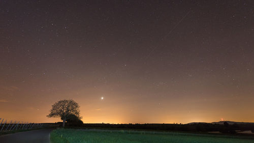 Scenic view of field against sky at night