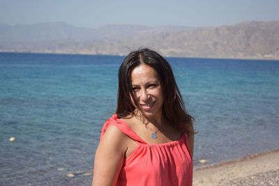 Rear view of woman standing on beach