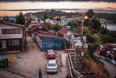 High angle view of street amidst houses against sky