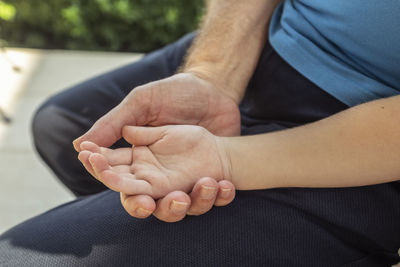 Midsection of man holding hands