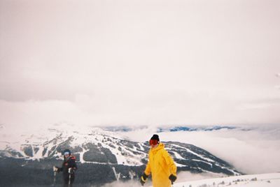 Rear view of man on snow against sky