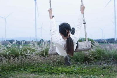 Full length of woman sitting on grass