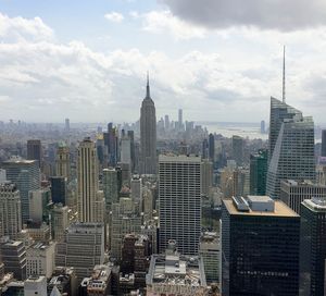 Buildings in city against cloudy sky