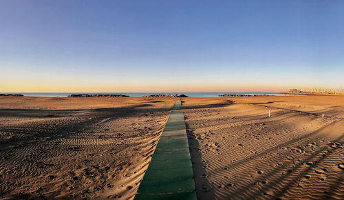 Scenic view of beach against clear sky