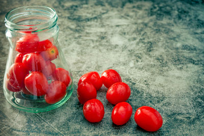 Close-up of red berries in glass jar on table