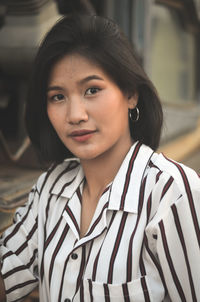 Portrait of smiling teenage girl standing outdoors