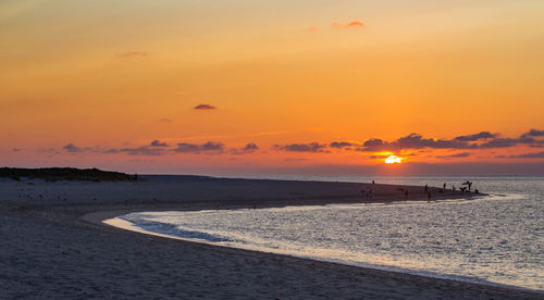Scenic view of beach against sky during sunset