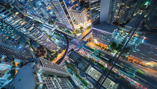 High angle view of illuminated buildings in city at night