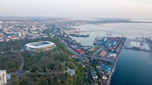 High angle view of buildings by sea against sky