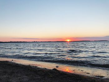 Scenic view of sea against clear sky during sunset