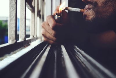 Close-up of man smoking at home