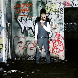 Full length of woman standing on graffiti wall