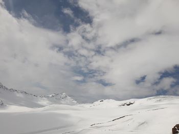 Scenic view of snow covered mountains against sky