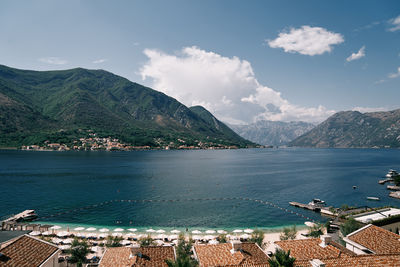 Scenic view of sea and mountains against sky